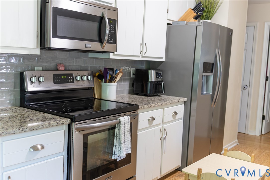 4924 Wilconna Road Chesterfield, VA 23832 - Photo 9 of 22 Kitchen featuring white cabinetry, speckled counte