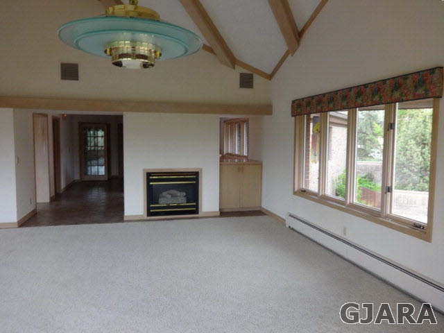 855 25 Road Grand Junction, CO 81505 - Photo 11 of 41 an empty room with a fireplace and fan