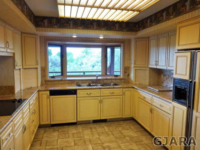 855 25 Road Grand Junction, CO 81505 - Photo 3 of 41 a kitchen with stainless steel appliances granite countertop a sink a stove and a refrigerator