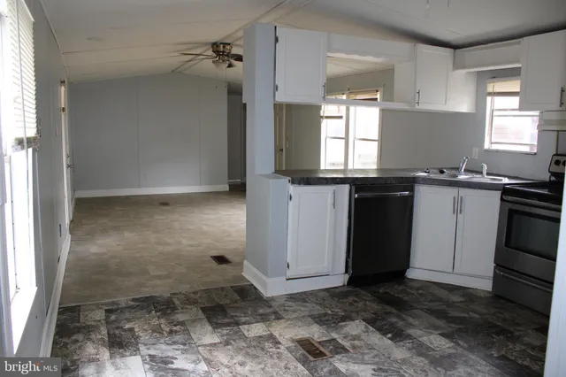 a kitchen with a stove sink and microwave