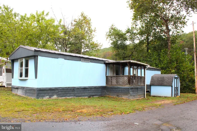 a view of a house with pool and sitting area