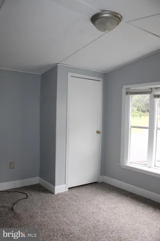 a white toilet sitting next to a bathroom sink and a shower