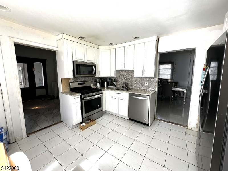 126 Bartholdi Avenue Butler, NJ 07405 - Photo 17 of 22 a kitchen with a stove a sink and a refrigerator