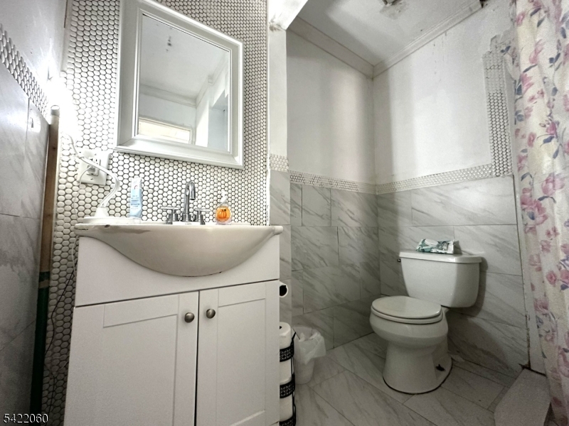 126 Bartholdi Avenue Butler, NJ 07405 - Photo 19 of 22 a bathroom with a toilet sink and mirror