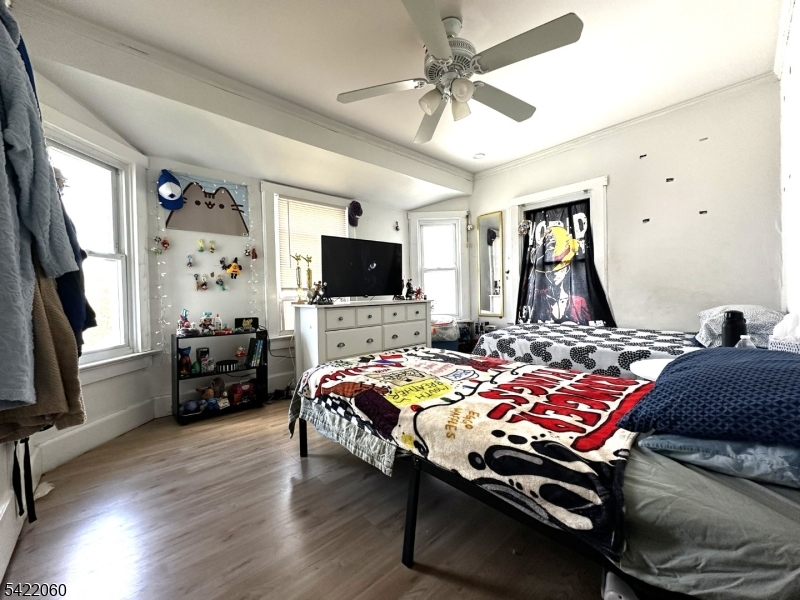 126 Bartholdi Avenue Butler, NJ 07405 - Photo 20 of 22 a bedroom with a bed and a flat screen tv