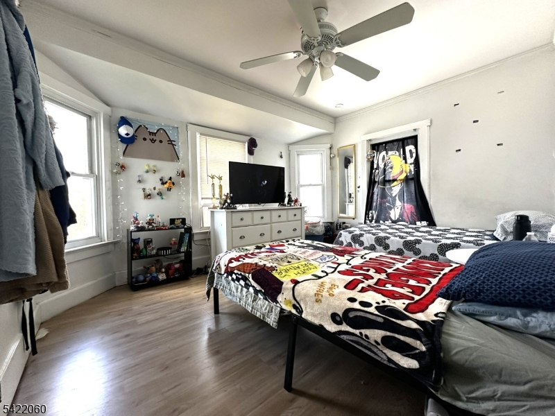 126 Bartholdi Avenue Butler, NJ 07405 - Photo 21 of 22 a bedroom with a bed and a flat screen tv