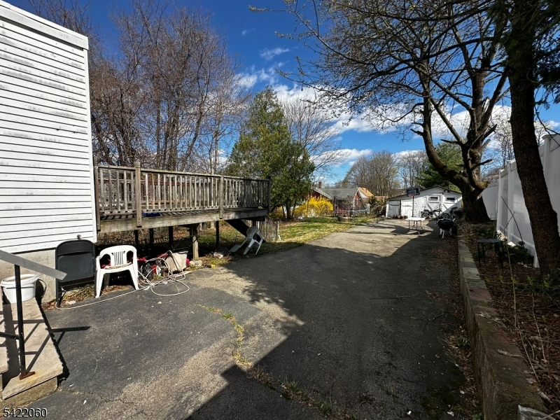 126 Bartholdi Avenue Butler, NJ 07405 - Photo 4 of 22 a view of a patio with table and chairs with wooden fence and plants