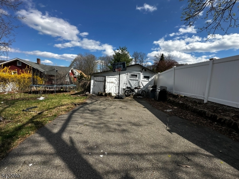 126 Bartholdi Avenue Butler, NJ 07405 - Photo 5 of 22 a view of a white house with a yard