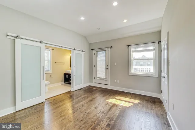 a bedroom with a bed and glass door