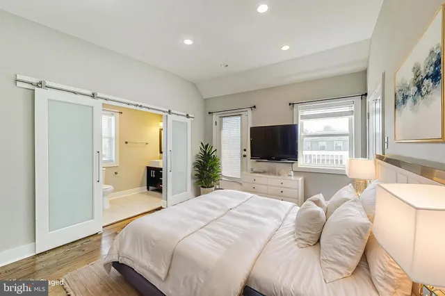 a bedroom with a large bed and a large window