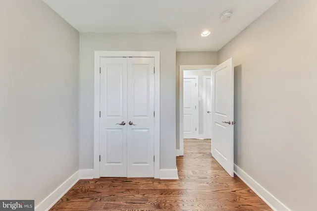 a view of a bedroom with a bed and a window