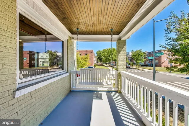 a view of a room with wooden floor and iron stairs
