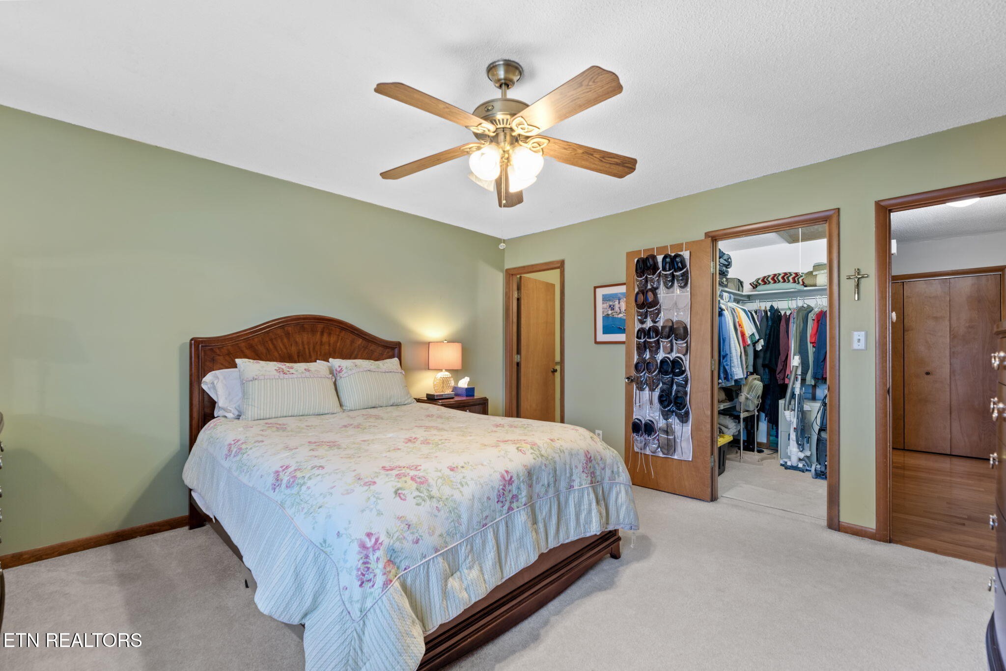 128 Hazleton Lane Oak Ridge, TN 37830 - Photo 20 of 28 a bedroom with a large bed and a chandelier
