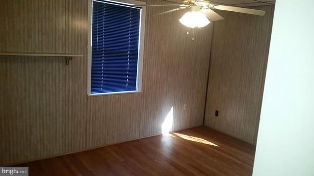 1832 Edgewood Road Baltimore, MD 21286 - Photo 8 of 13 a view of an empty room with wooden floor and a window