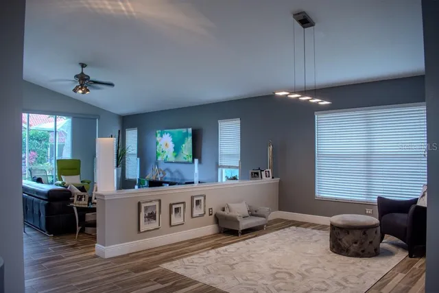 a living room with furniture and a wooden floor