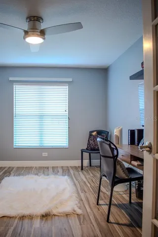 a view of a workspace with furniture and a window