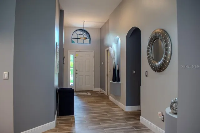 a view of a hallway with wooden floor