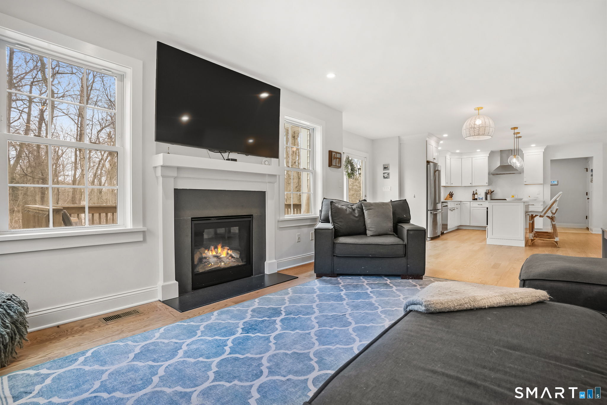 153 North Street Trumbull, CT 06611 - Photo 11 of 27 Gas fireplace with sliding doors providing easy access to the deck