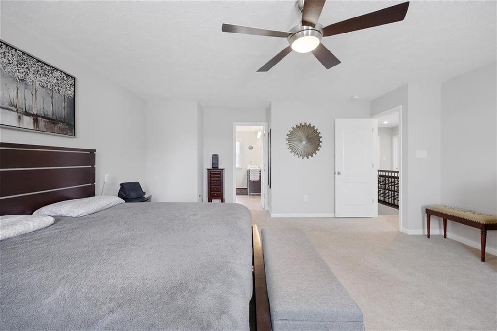 233 Wyncrest Drive Butler, PA 16001 - Photo 18 of 25 a bedroom with a bed and a chandelier