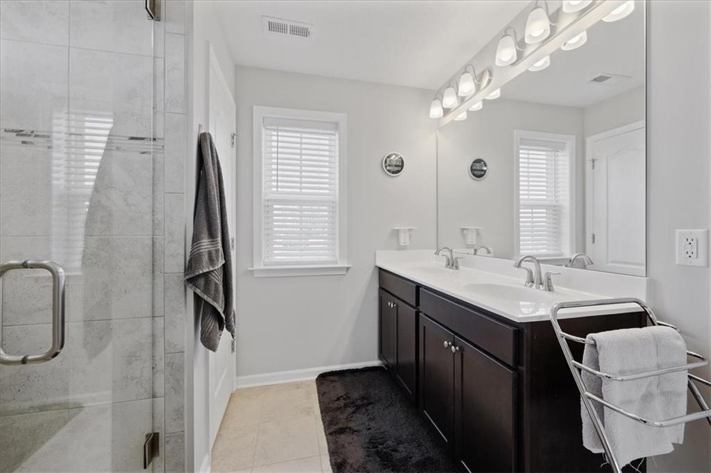 233 Wyncrest Drive Butler, PA 16001 - Photo 20 of 25 a bathroom with a double vanity sink a toilet a mirror and window
