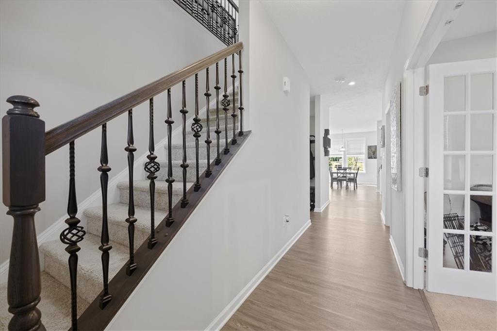 233 Wyncrest Drive Butler, PA 16001 - Photo 3 of 25 a view of a hallway with wooden floor and staircase
