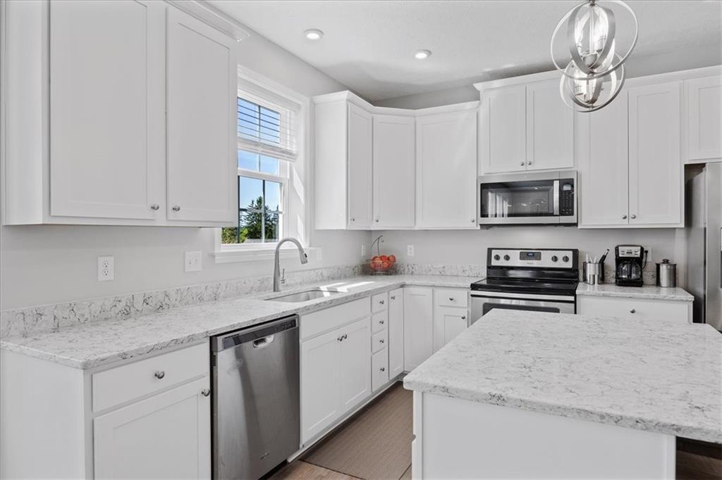 233 Wyncrest Drive Butler, PA 16001 - Photo 6 of 25 a kitchen with granite countertop a sink a stove and cabinets
