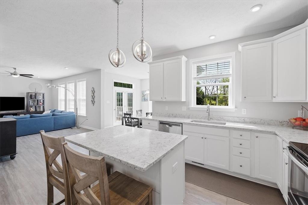 233 Wyncrest Drive Butler, PA 16001 - Photo 7 of 25 a large kitchen with granite countertop a stove a sink a dining table and chairs