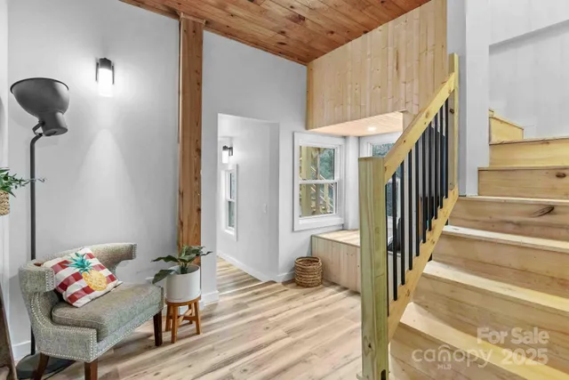 a view of a livingroom with wooden floor and furniture