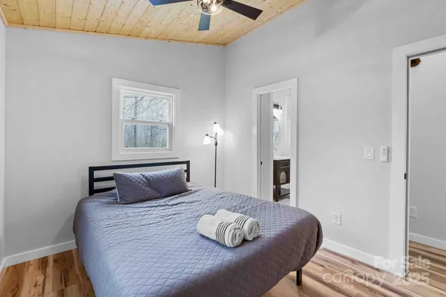 a bedroom with a large bed and a window