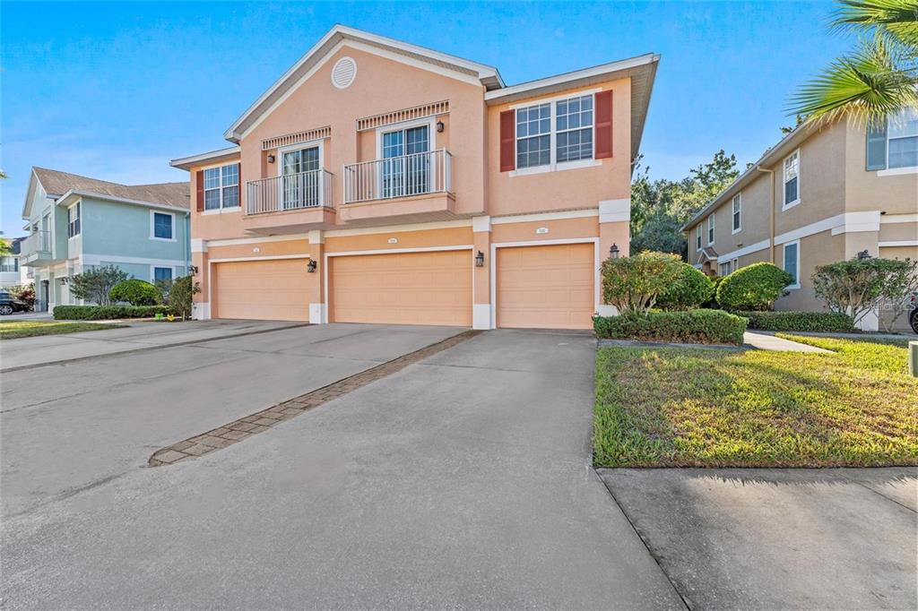 5310 Anhinga Trail New Port Richey, FL 34653 - Photo 2 of 27 a front view of a house with a yard and garage