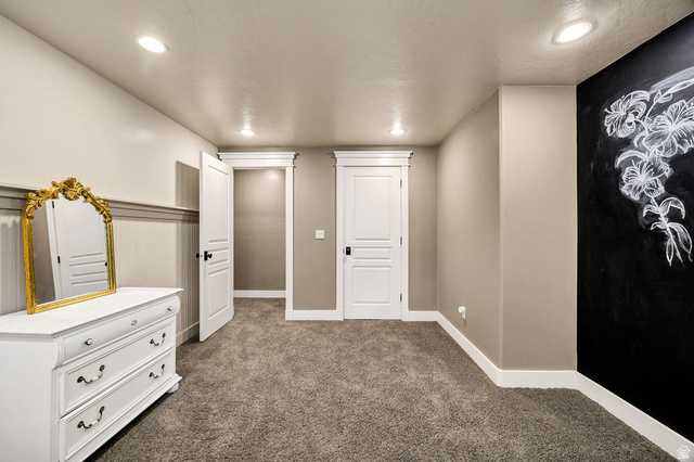 288 525 South Providence, UT 84332 - Photo 39 of 71 Carpeted room featuring recessed lighting, a chalkboard wall, white paneled doors, and wainscoting with a chair rail