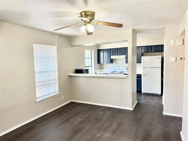 a view of kitchen with cabinets appliances and wooden floor