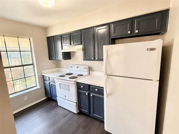 a kitchen with stainless steel appliances a refrigerator sink and microwave