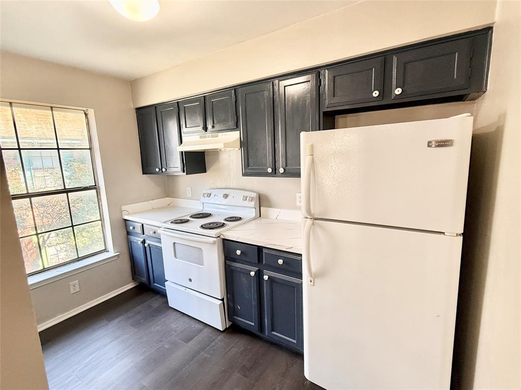 2221 Stella Street, Unit 4 Denton, TX 76201 - Photo 4 of 11 a kitchen with stainless steel appliances a refrigerator sink and microwave