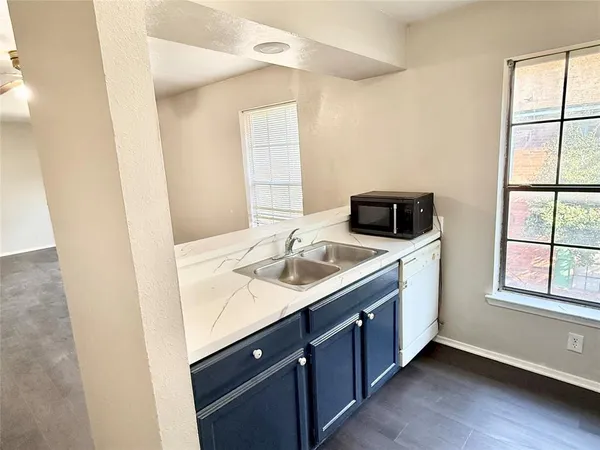 a kitchen with a sink and a window