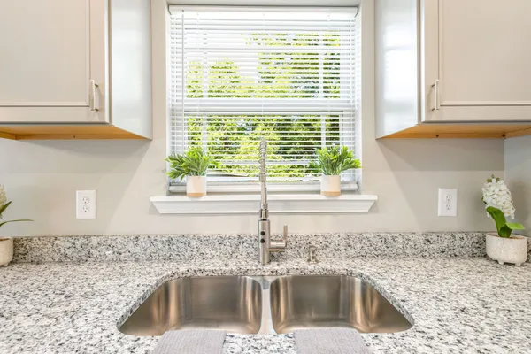 a kitchen with granite countertop a sink and a window