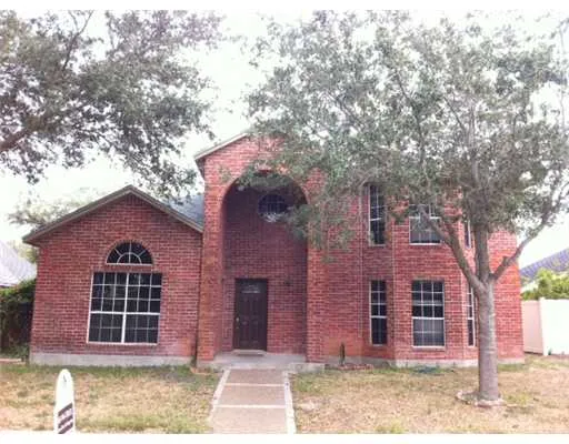 a front view of a house with a tree