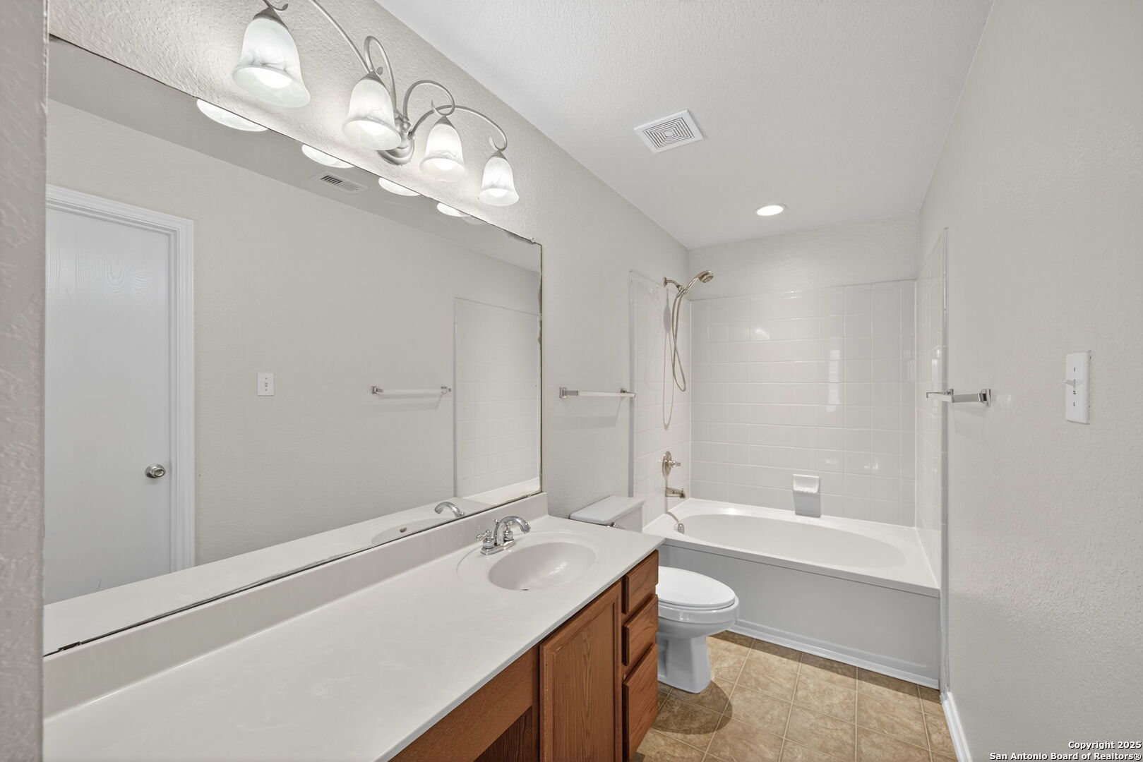 7719 Mesquite Farm San Antonio, TX 78239 - Photo 20 of 27 a bathroom with a sink a toilet and shower