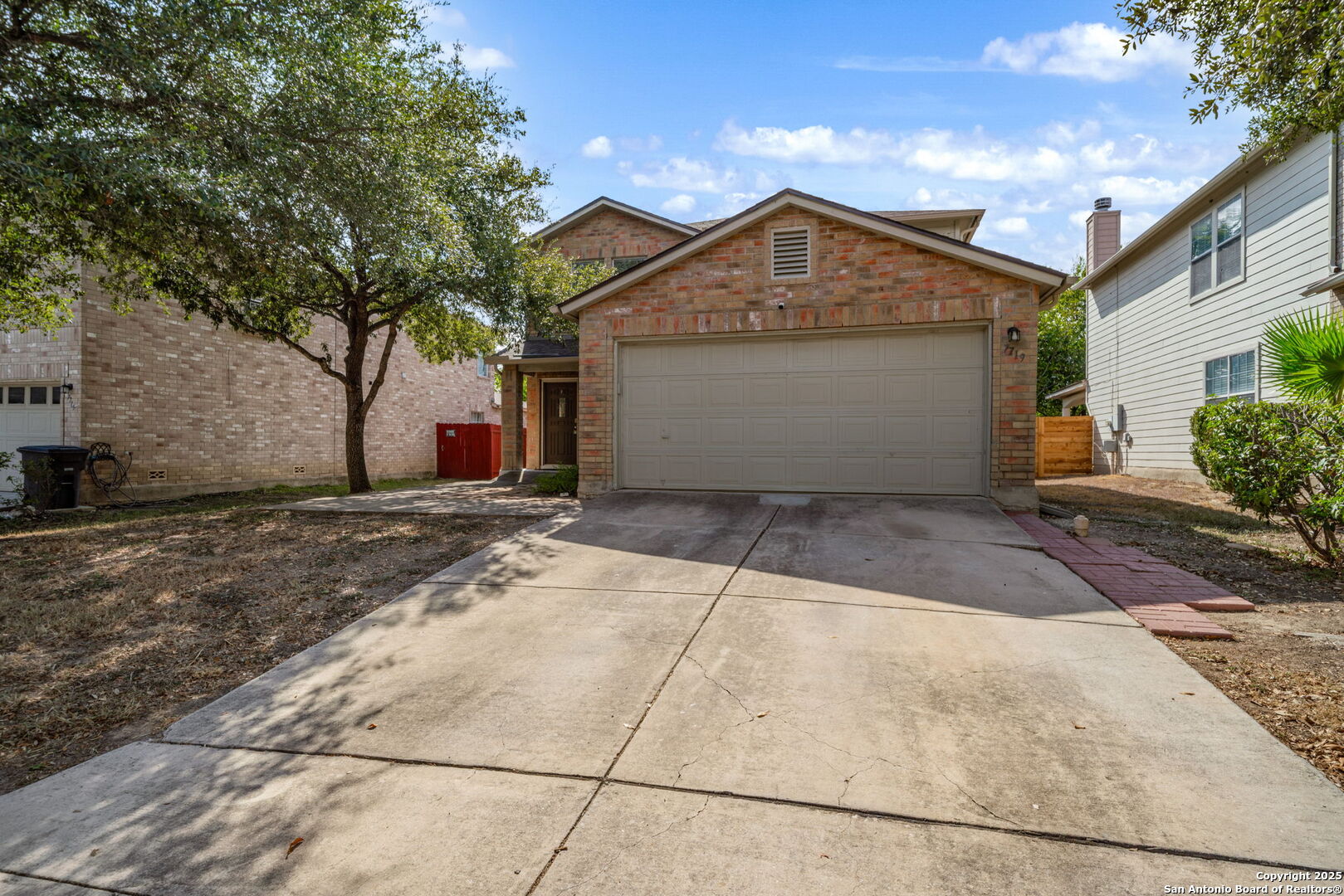7719 Mesquite Farm San Antonio, TX 78239 - Photo 2 of 27 a view of garage yard and tree