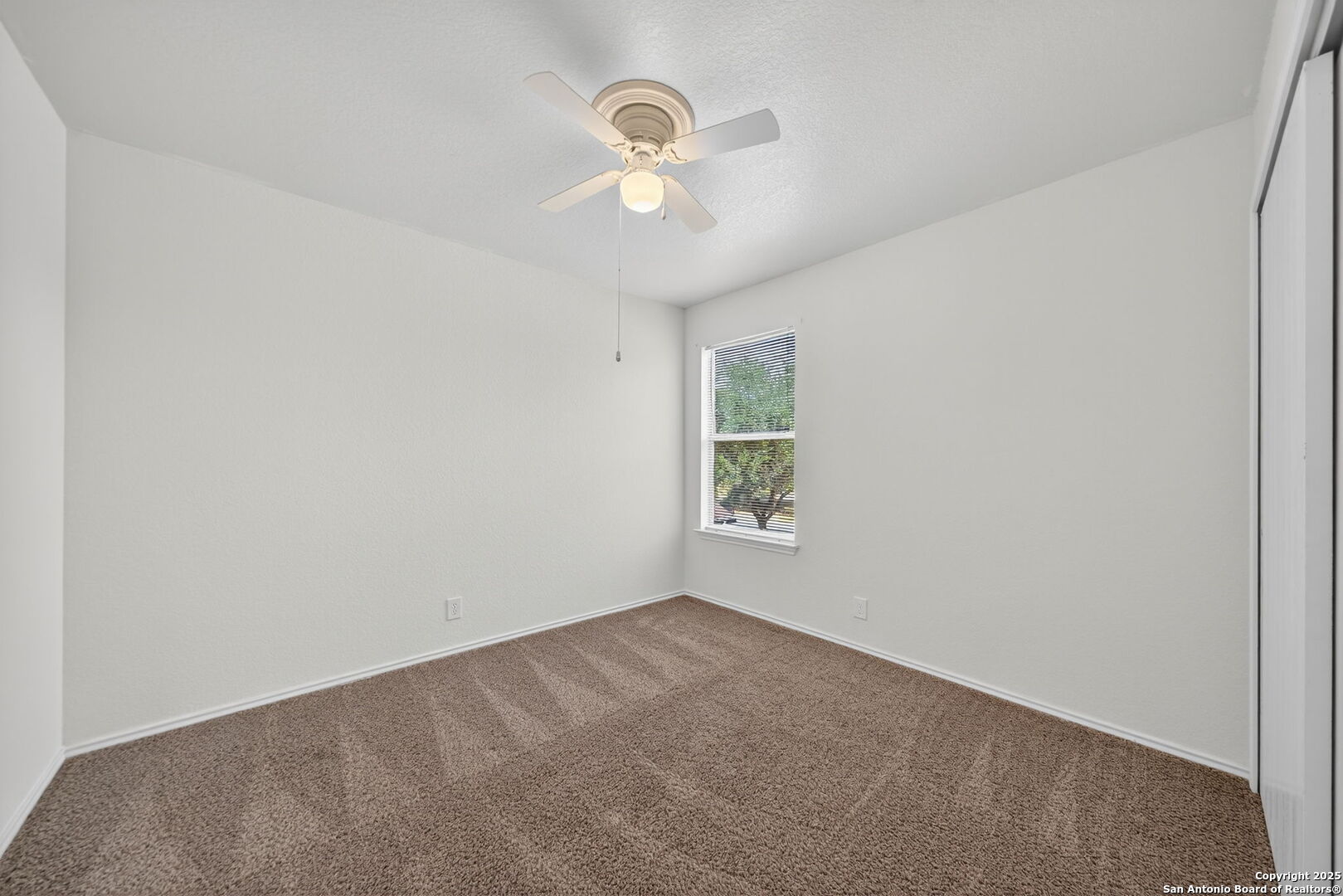 7719 Mesquite Farm San Antonio, TX 78239 - Photo 22 of 27 an empty room with windows