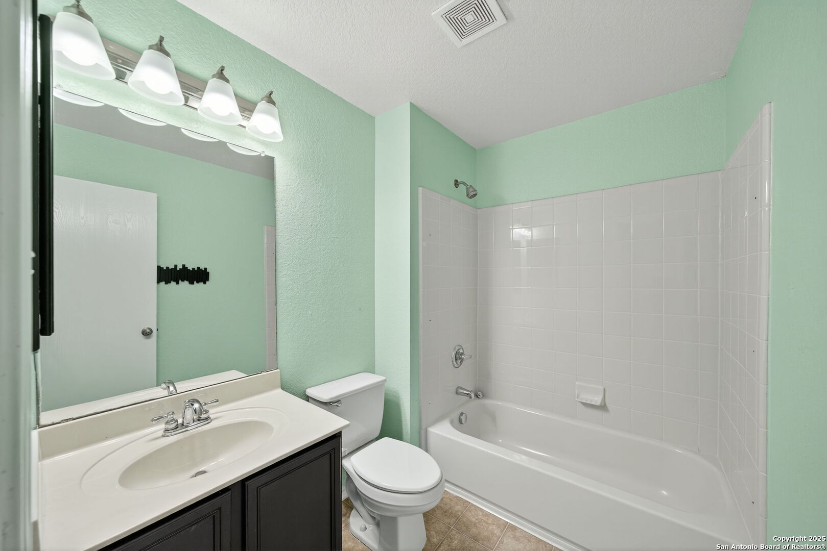 7719 Mesquite Farm San Antonio, TX 78239 - Photo 23 of 27 a bathroom with a sink a toilet and shower