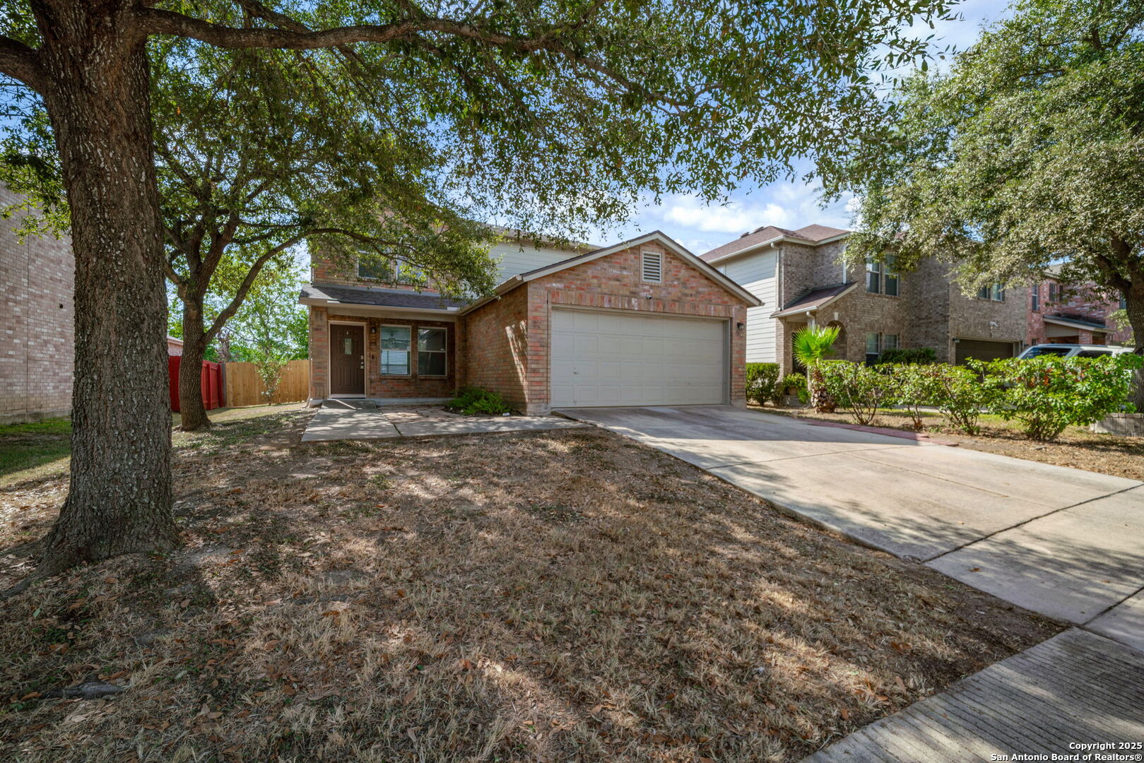 7719 Mesquite Farm San Antonio, TX 78239 - Photo 3 of 27 a front view of a house with a garden