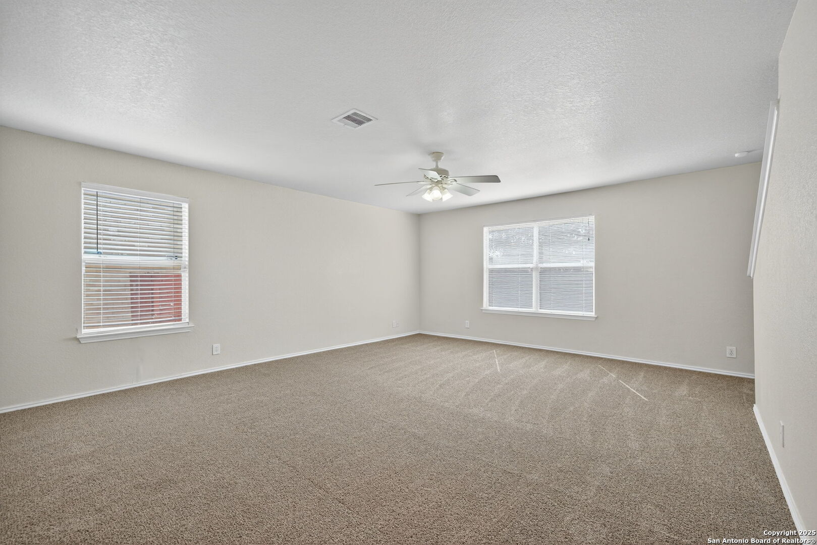7719 Mesquite Farm San Antonio, TX 78239 - Photo 7 of 27 a view of an empty room with a window