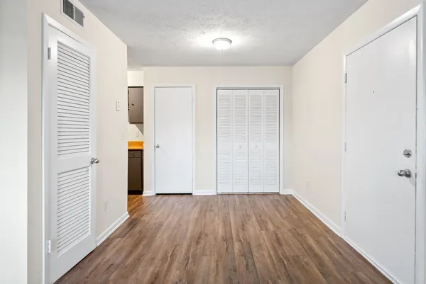 a view of hallway with wooden floor