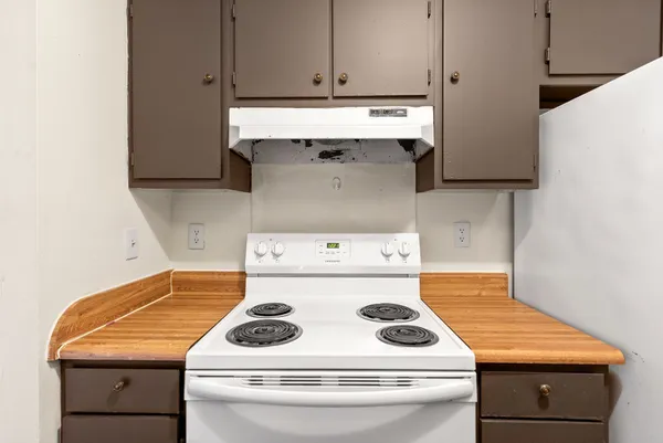 a kitchen with a stove and a microwave
