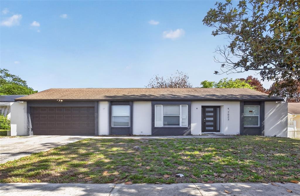 7023 Talbot Drive Orlando, FL 32819 - Photo 1 of 34 a view of a brick house with a large windows and a yard