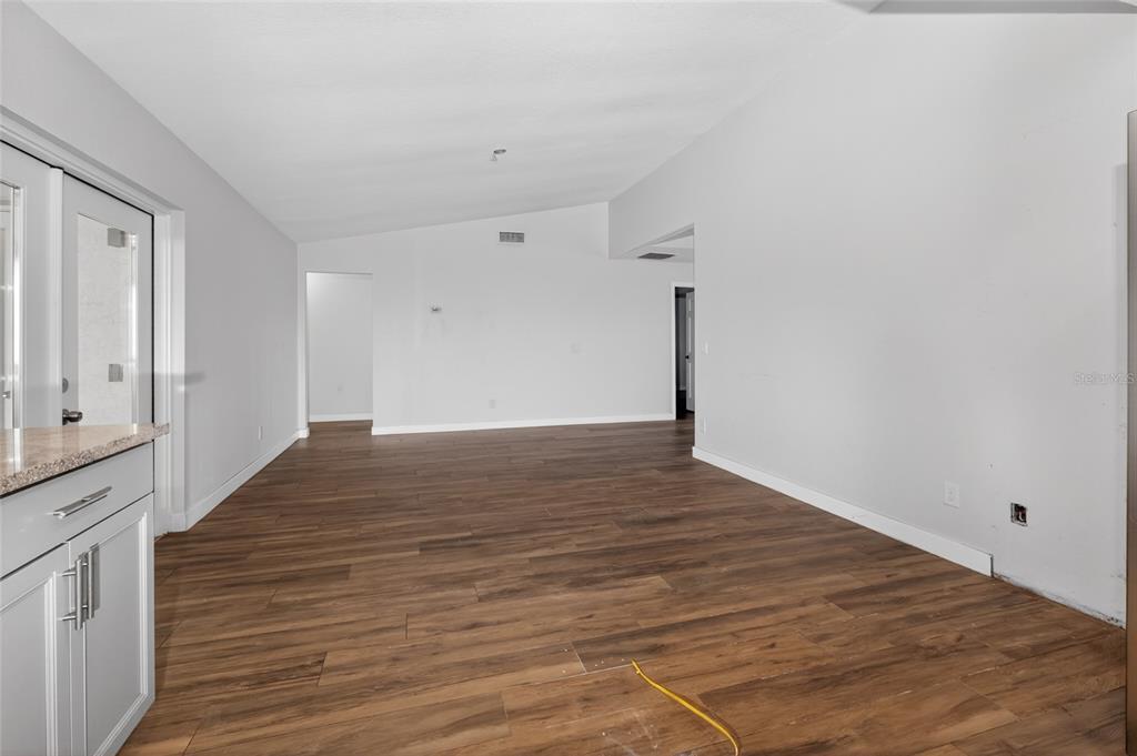 7023 Talbot Drive Orlando, FL 32819 - Photo 12 of 34 a view of an empty room with wooden floor