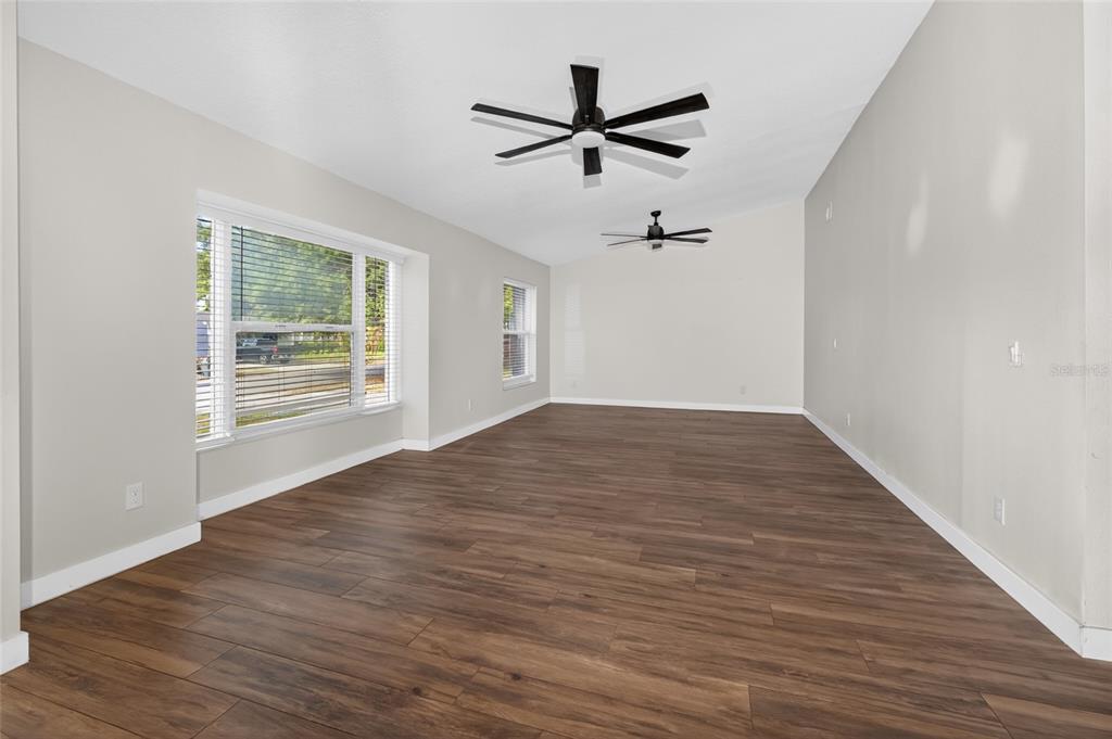 7023 Talbot Drive Orlando, FL 32819 - Photo 14 of 34 wooden floor in an empty room with a window
