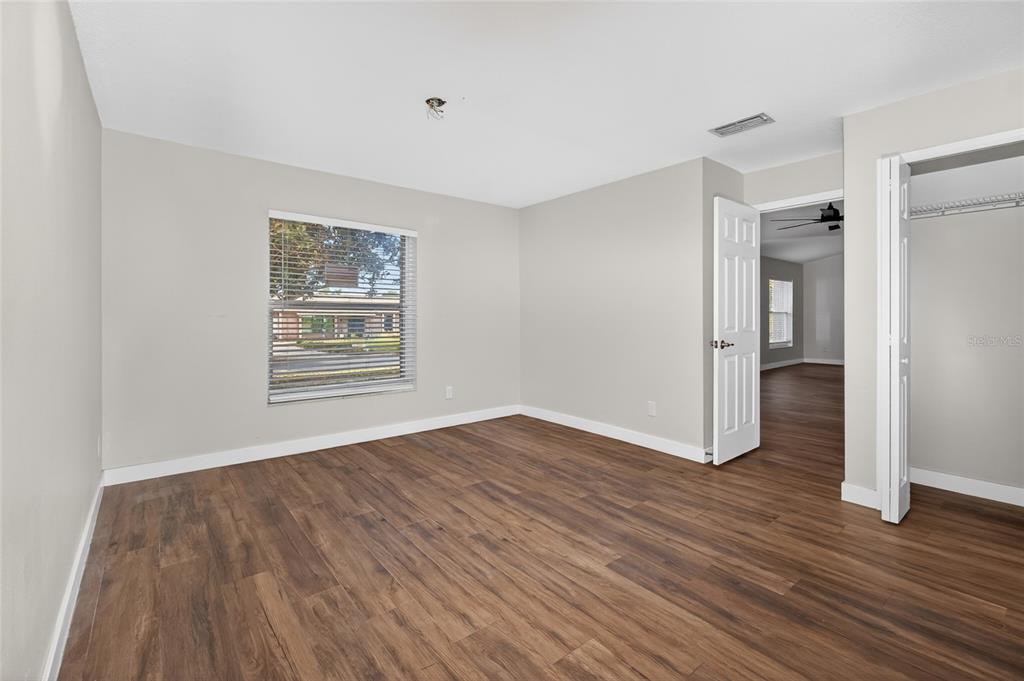 7023 Talbot Drive Orlando, FL 32819 - Photo 15 of 34 an empty room with wooden floor and windows