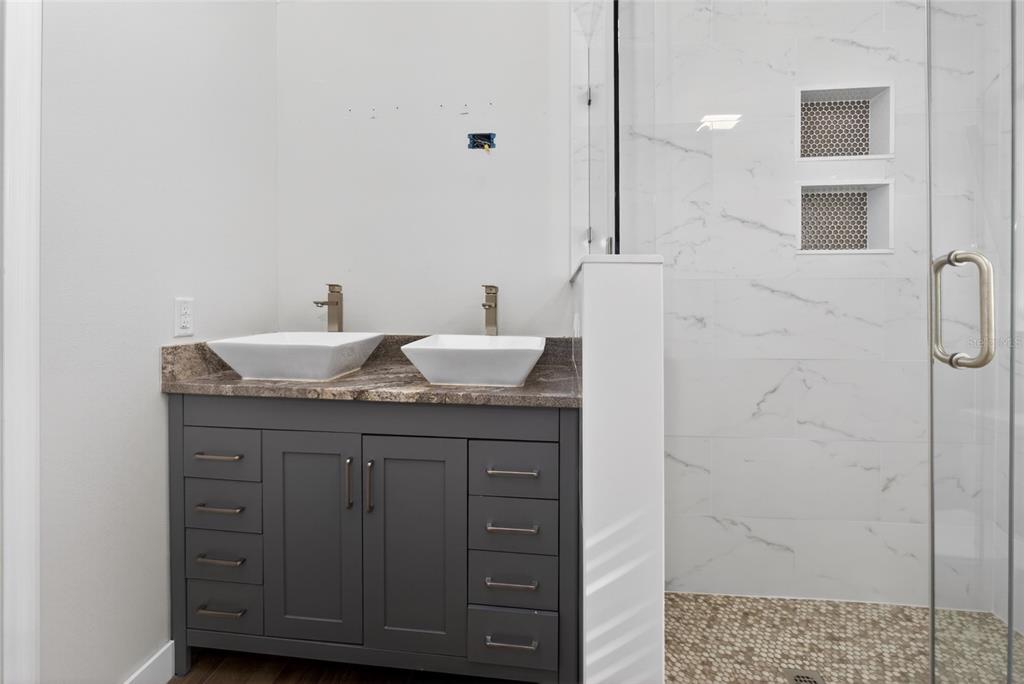 7023 Talbot Drive Orlando, FL 32819 - Photo 18 of 34 a bathroom with a granite countertop sink and a mirror